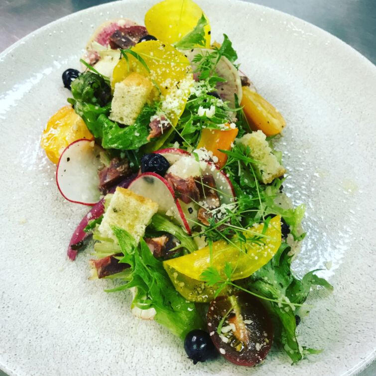 A colorful assortment of fruits and vegetables beautifully presented on a white plate.