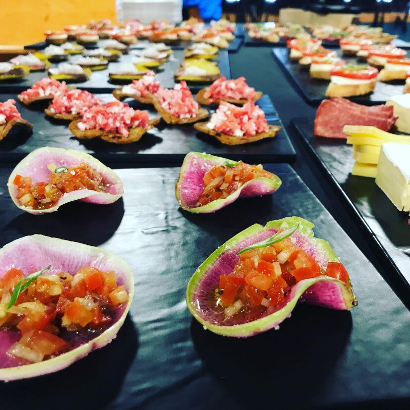 A table displaying an assortment of appetizers elegantly arranged on sleek black trays.
