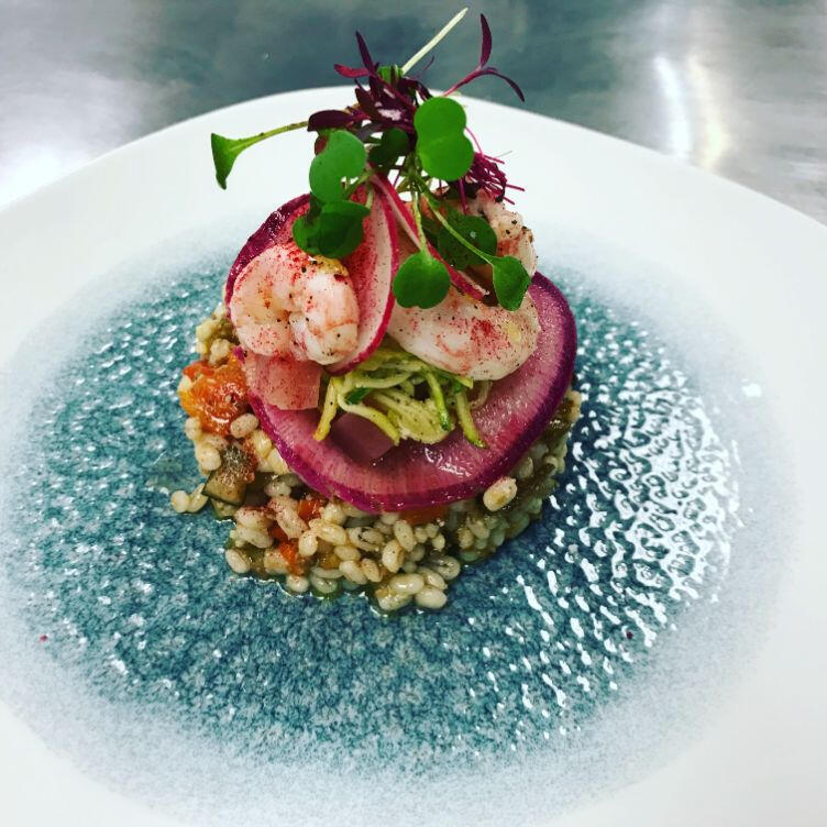 A gourmet dish served on a plate, elegantly garnished, highlighting the artistry of culinary presentation.